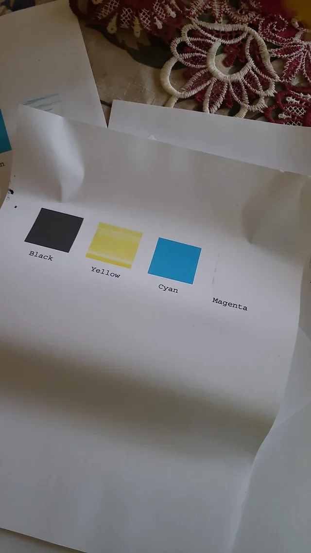 Photographed printer test with black, yellow and cyan present while the magenta area is missing